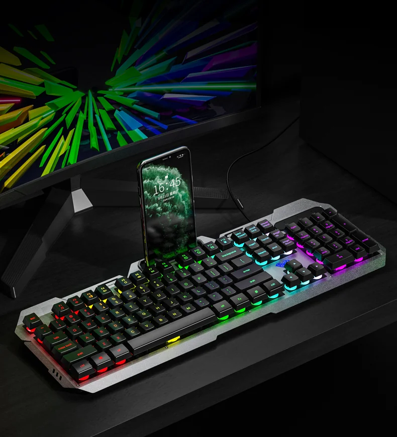 AULA F2023 on a desk: a phone standing in the top-panel slot with the key lighting on