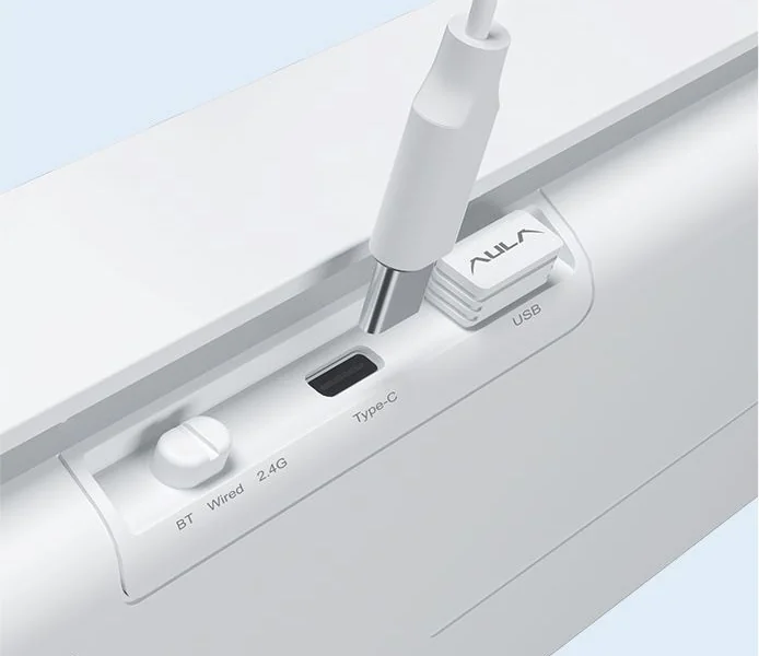 The AULA S100 Pro's underside: the BT / Wired / 2.4G slider, the Type-C port and the 2.4 GHz receiver in its recess