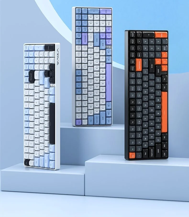 AULA's official line-up: the grey and black S100 with orange accents on the right, beside two light S100 Pro colourways