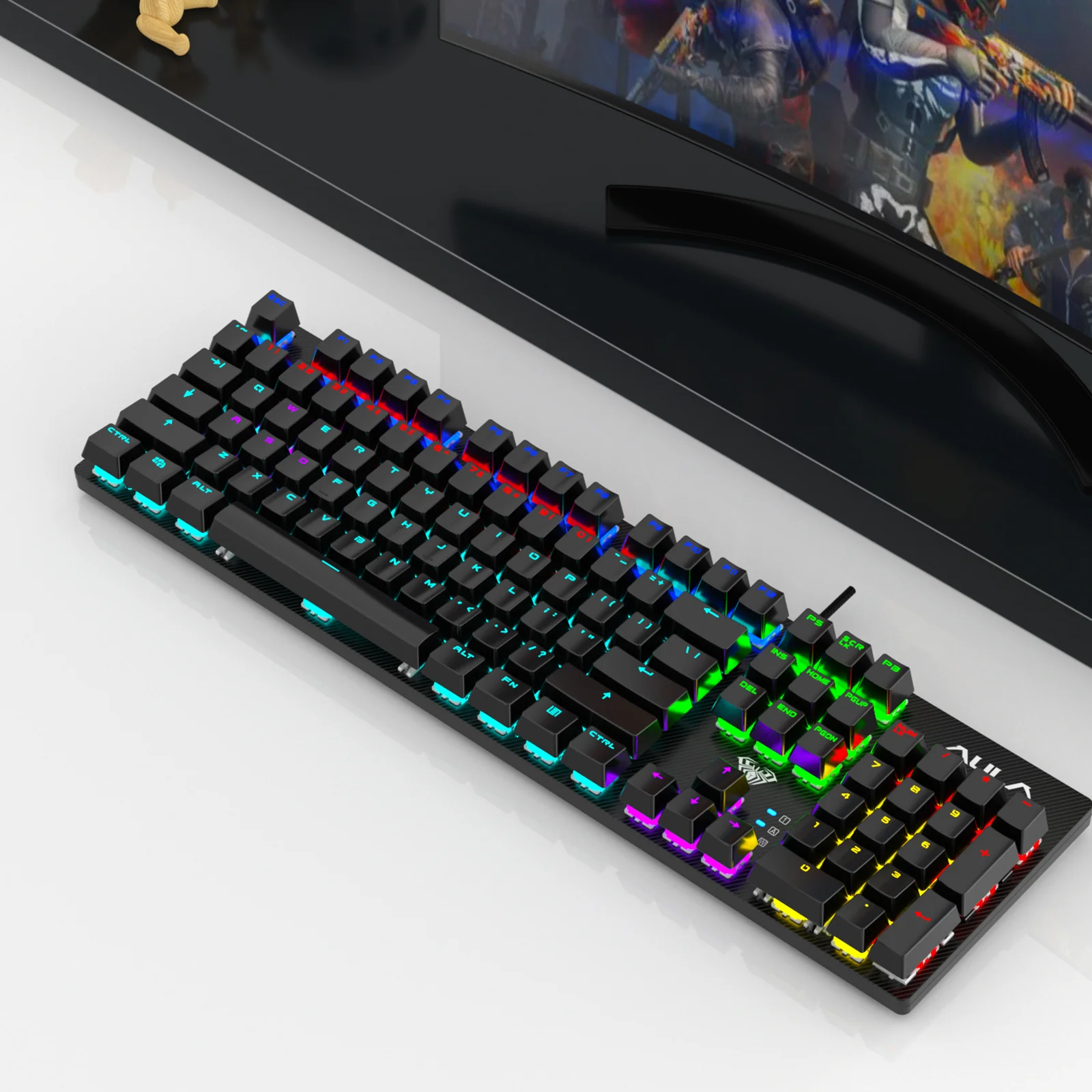 The AULA S2022 on a desk in front of a monitor, its keys lit in different colours