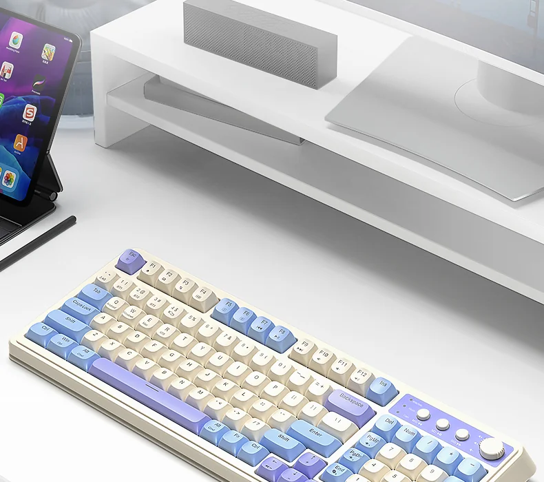 The AULA S99 on a desk with a monitor and a tablet