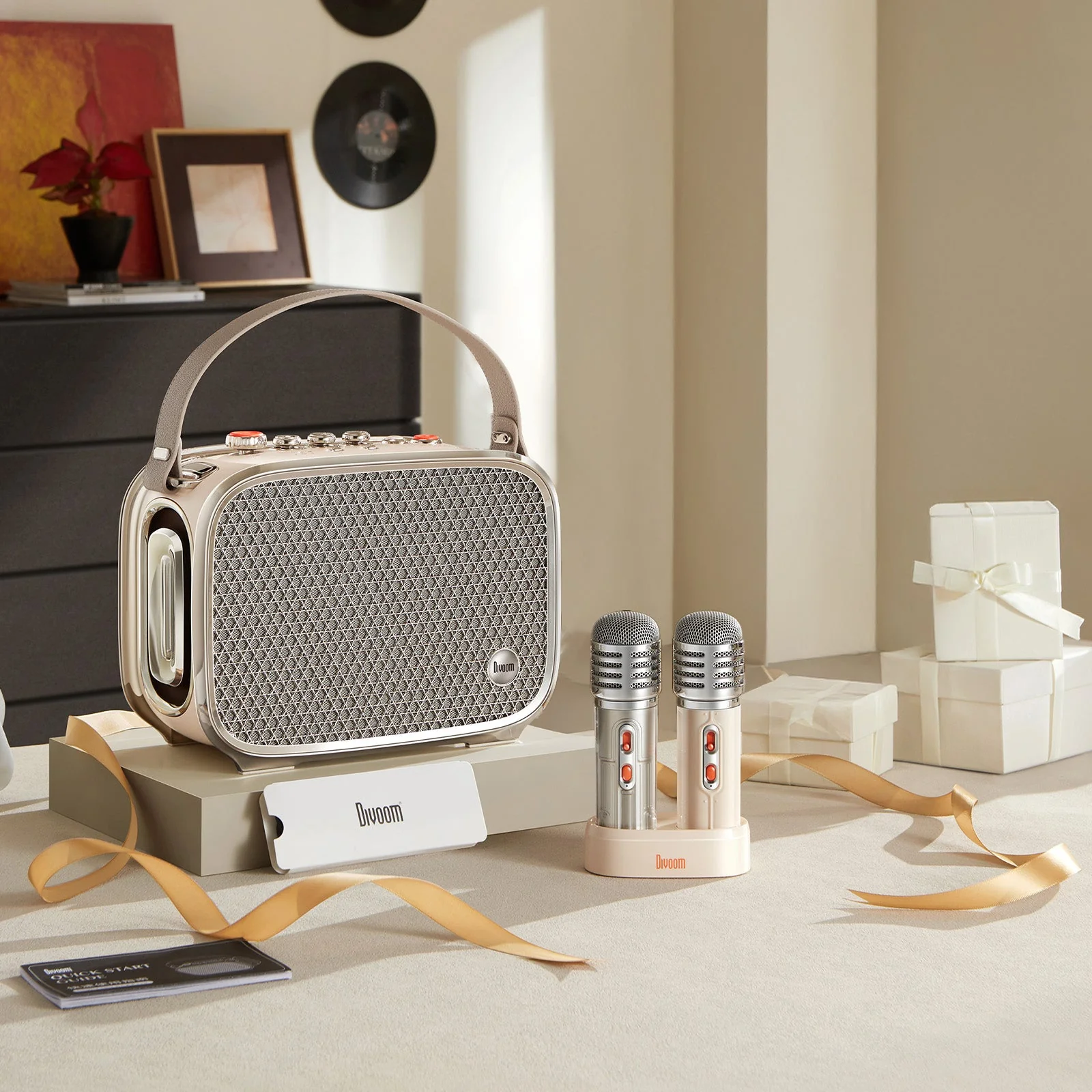Divoom SongBird-Ultra in white: the speaker and the microphones on their stand among gift boxes